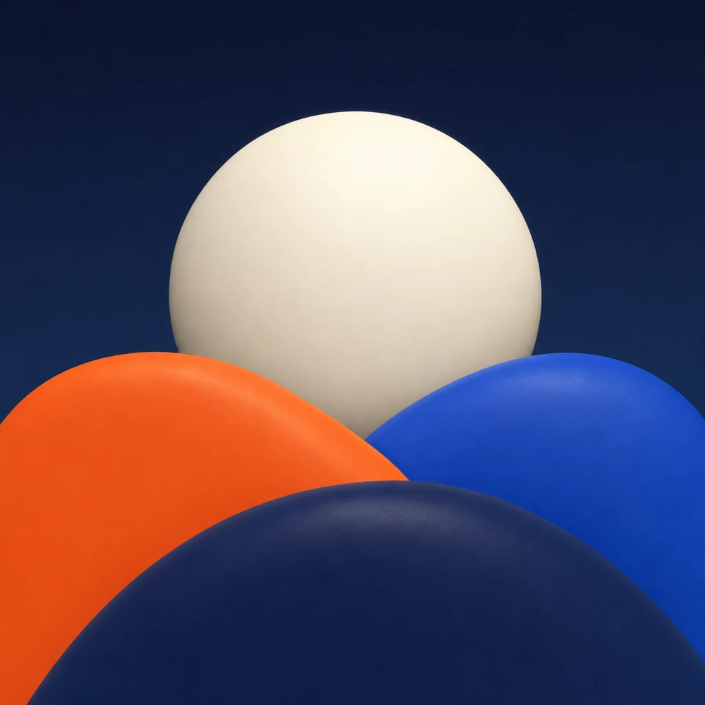 A pearl moon rising behind an orange, a cobalt and a navy hill